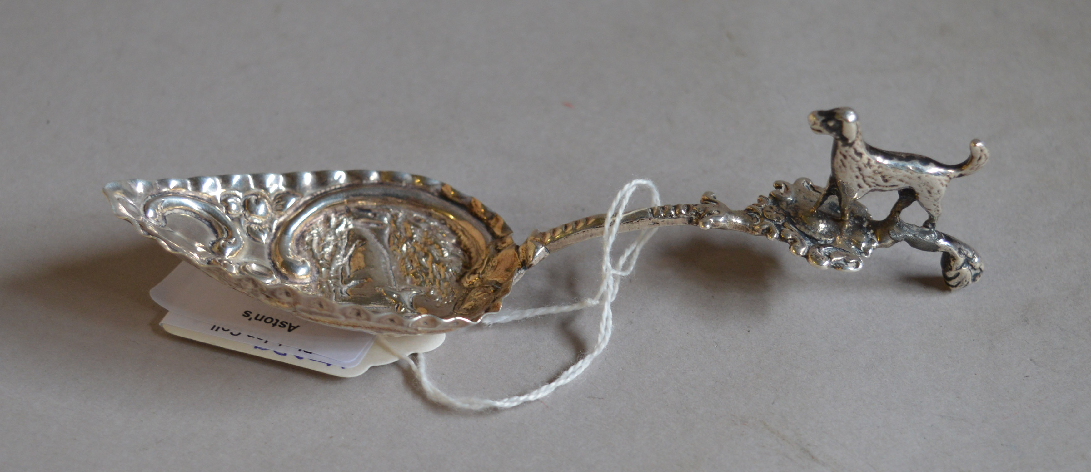 HM silver spoon with dog adornment.