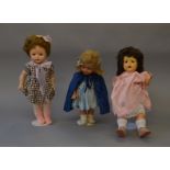 Three composition dolls, height of tallest 55 cm.