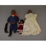 Three reproduction bisque head black dolls, height of tallest 50 cm.