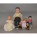 Four composition dolls, height of tallest 52 cm. Together with two small dolls in national dress.