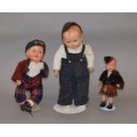 Three composition dolls, two in Highland dress, height of tallest 45 cm. Some crazing.