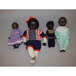 Four plastic black dolls, height of tallest 60 cm.