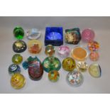 23 assorted glass and plastic paperweights including Caithness examples.