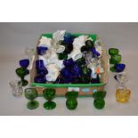 A good quantity of coloured blue, green and clear glass eyebaths,