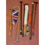 Collection of parasols and walking sticks.