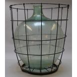 A large moulded glass bomb terrarium with metal cage. Height 60cm.