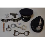 Mixed lot of police collectables including caps and hadcuffs.