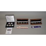 3 Cased sets of comemmorative coins including silver examples.