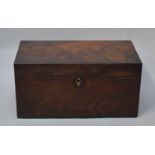 A Georgian flame mahogany two division tea caddy with glass mixing bowl.