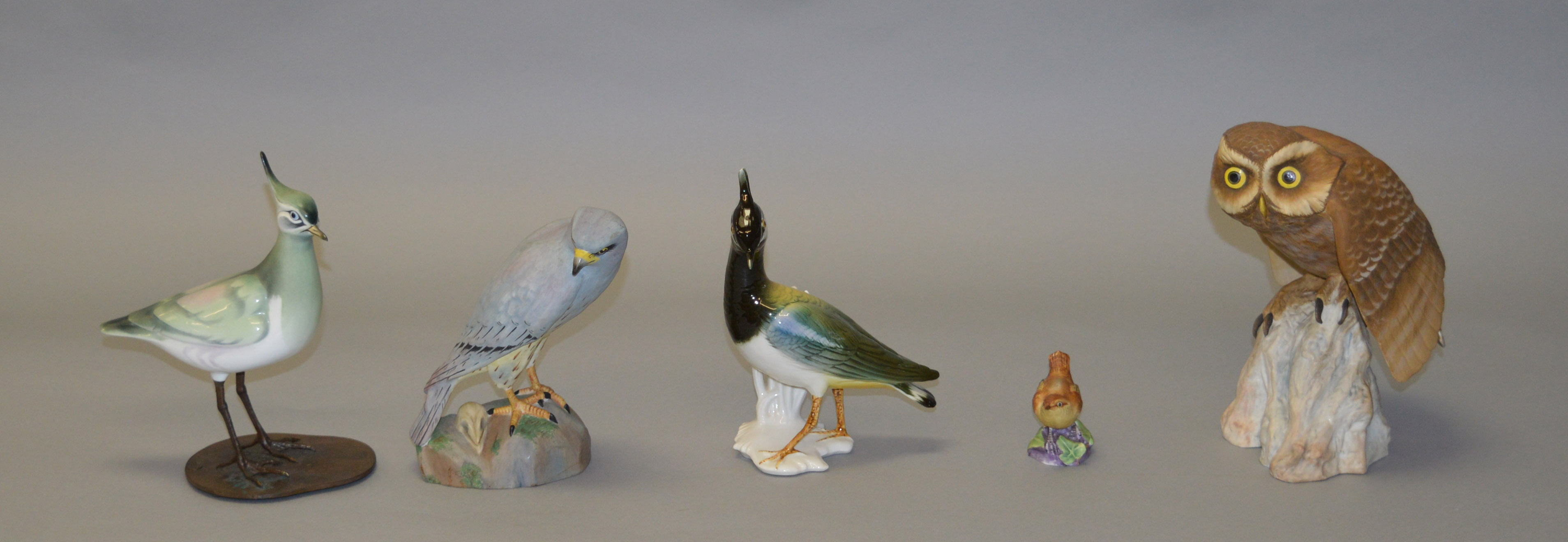 An Albany Worcester porcelain bird on metal legs and base, height 21cm,