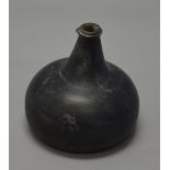 A 17th/18th century wine bottle, black glass with onion form.