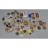 A collection of assorted medals, badges and militaria including cap badges,