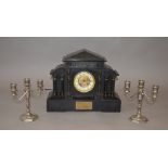 An early 20th century ornate cased chiming mantle clock with enamel face,