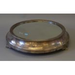 A large Walker and Hall mirrored cake stand of circular form with three pedestal feet.