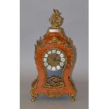 A reproduction French style chiming mantle clock with walnut burr and ormalu style design,