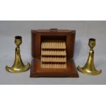 An oak cigarette dispenser together with a pair of brass Art Nouveau style candlesticks.