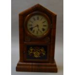 An American Eight Day movement chiming mantle clock with tin face and coat of arms panel to