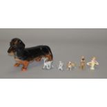 A Beswick Daschhund togther with 4 Disney Wade Whimsies and a pin cushion lady (6)