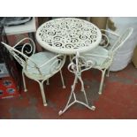 Metal garden table and chairs and a plant stand