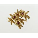 An 18ct H/M ruby set floral brooch, approx 10.