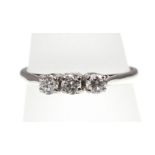 A three-stone diamond ring stamped 18ct, approx total weight 0.45ct & 2.