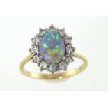 An 18ct H/M fiery opal & diamond cluster ring, approx total diamond weight 0.75cts & 5.