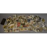 A quantity of assorted vintage postcards including embroidered early 20th century examples.