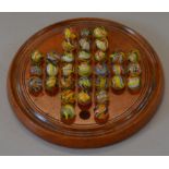 A vintage solitaire set with 32 vintage hand-made marbles