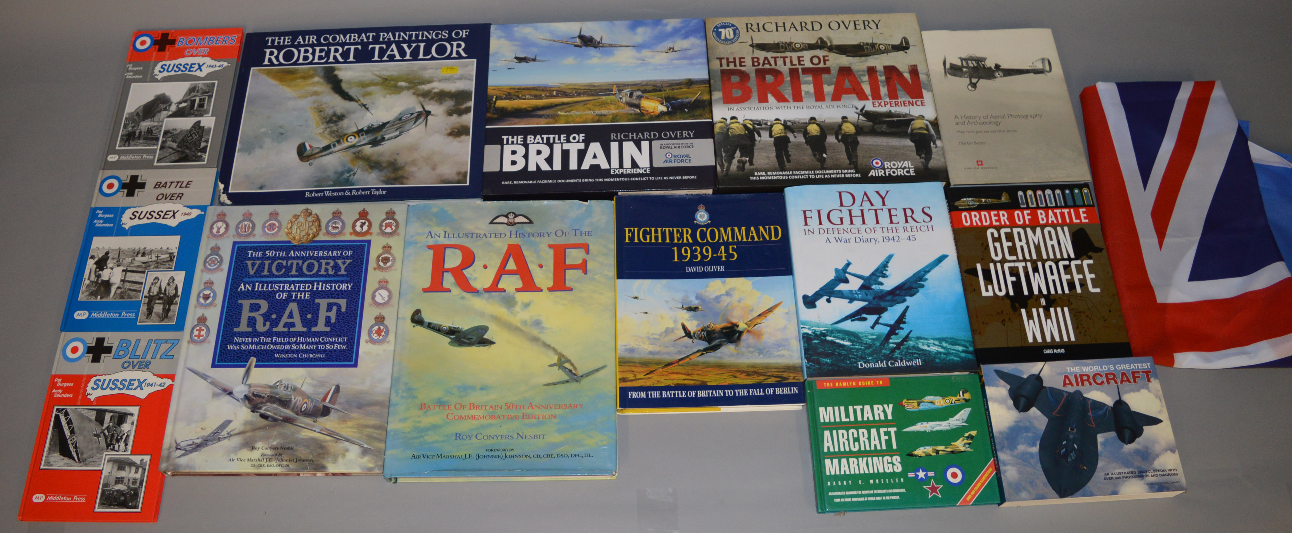 25 RAF/ Aviation and War related books together with a Union Jack flag with RAF emblem.