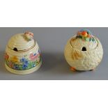 A Clarice Cliff "Harvest" jam pot together with a bee hive example (2)