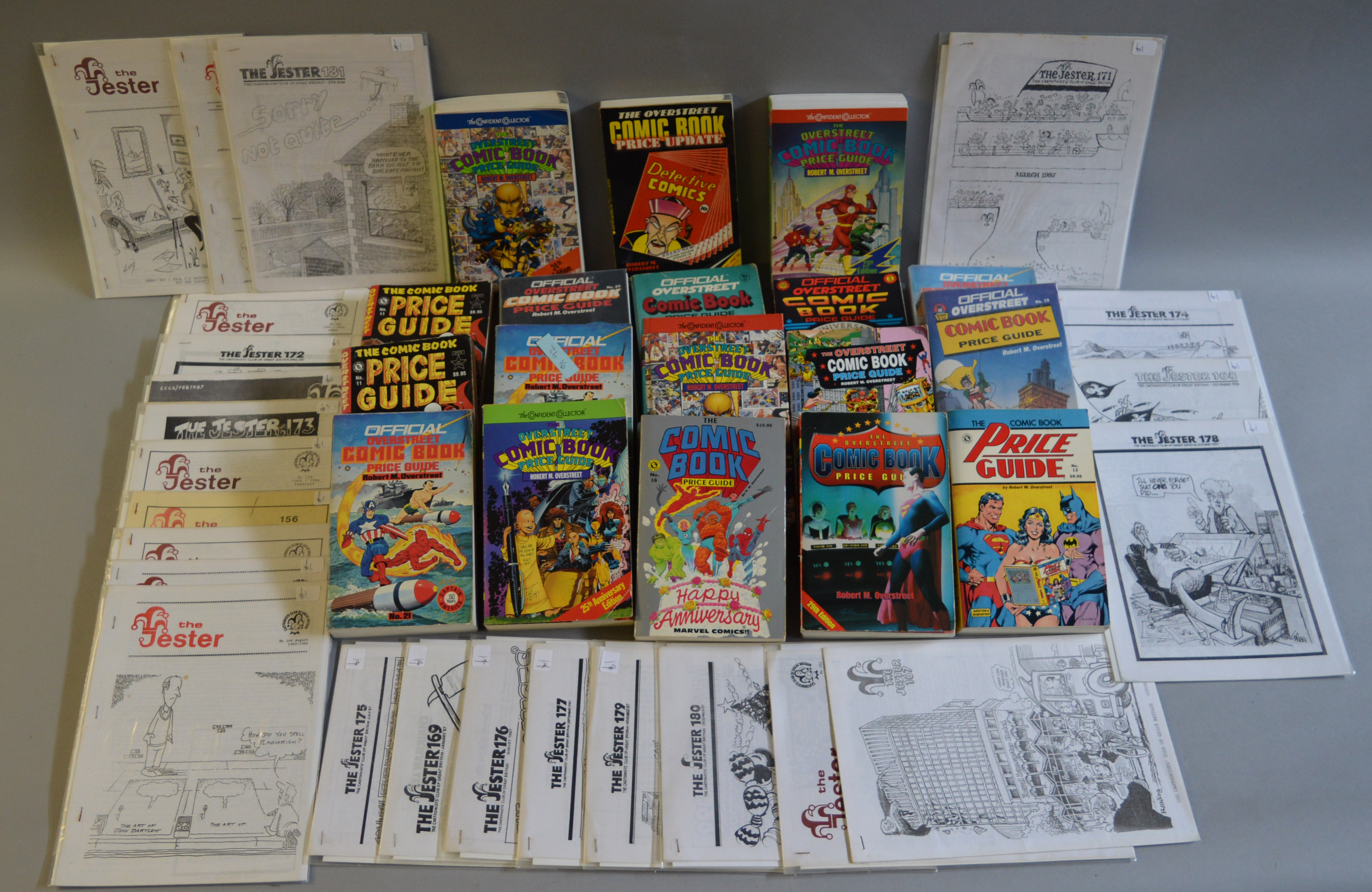 18 Comic book price guides together with some Jester comic books.