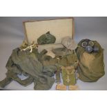 A quantity of WW2 and 1950s era military apparel and similar including gas masks, sacks,