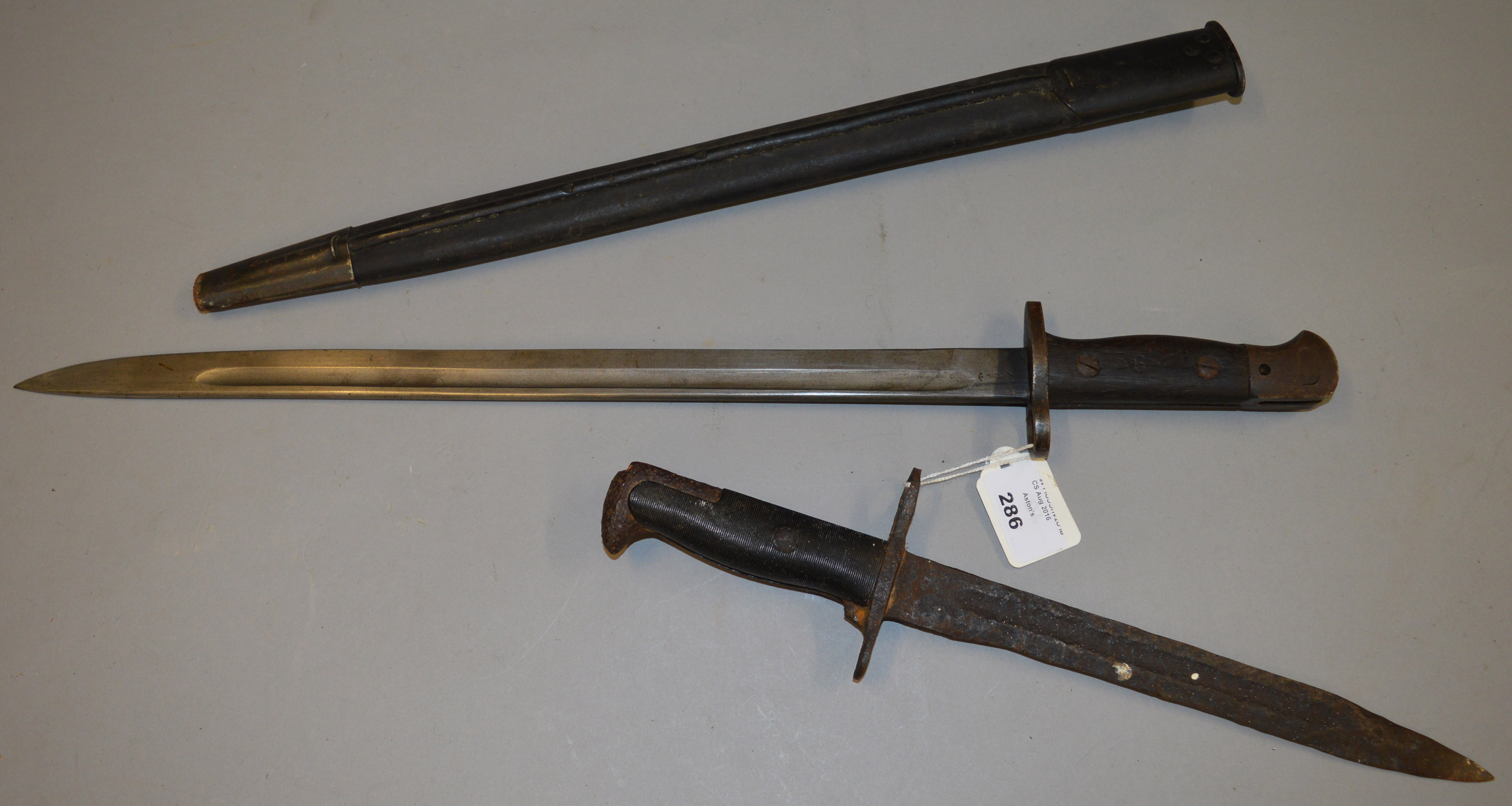 A 1907 bayonet marked WSC 1907, with sheath together with a smaller example.