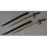 A pair of French bayonets with sheaths, marked 1873 to blade. Both 71cm long.