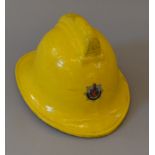 A fiberglass fireman's helmet- Greater Manchester County Fire Service. Stamped 1988 to interior.