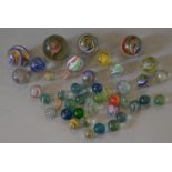 40+ vintage hand-made marbles, various sizes and patterns. Varying conditions.