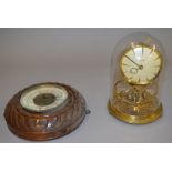 A Kundo dome clock with glass dome. 23cm tall. Togeth with a J. A. Seckel & Zonen.