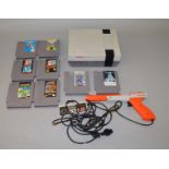 Nintendo Entertainment System (NES) unboxed with light gun, 1 controller & 8 unboxed games.