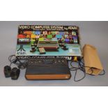 Atari games consul, with 2 paddle hand controllers, no power supply, in tatty box.