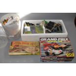 A boxed Scalextric Grand Prix Set together with a large box of railway buildings,