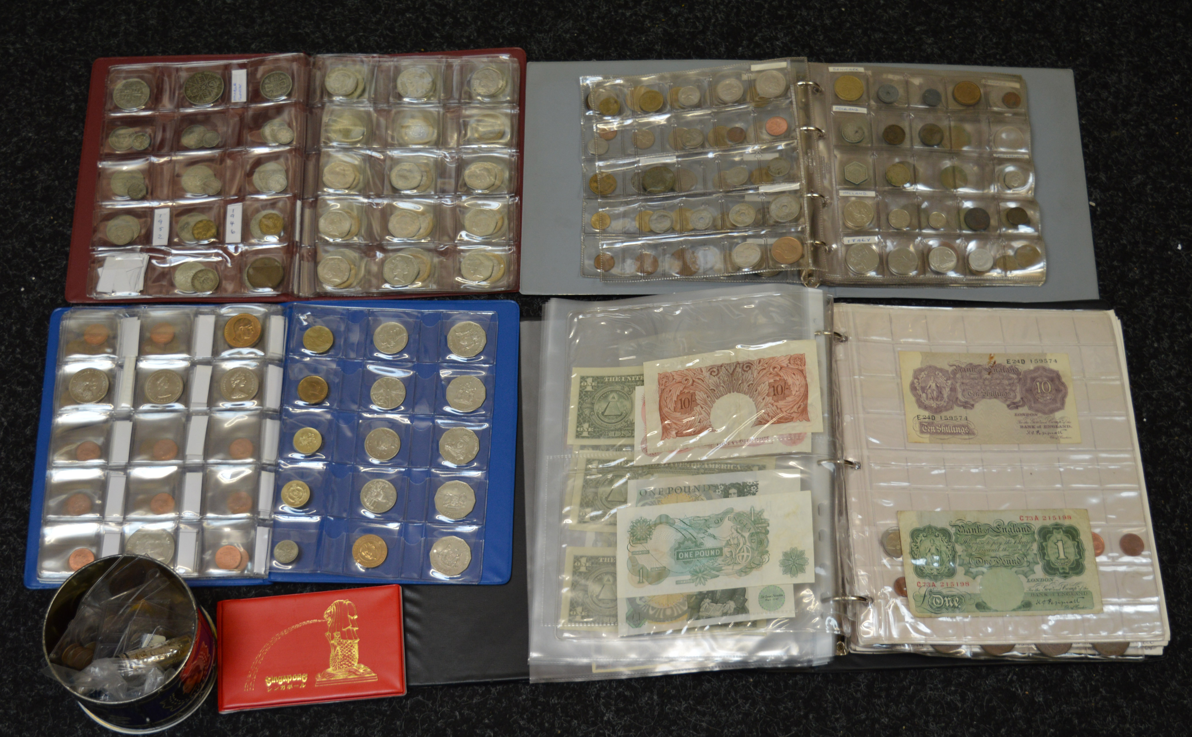 A boxed quantity of coins in albums including £5 coins, £2 coins, pre 47, foreign odds,