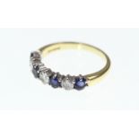 An 18ct H/M sapphire and diamond 7 stone half eternity ring, approx diamond weight 0.