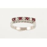 An 18ct H/M white gold seven stone ruby and diamond ring, the diamonds totalling approx 0.