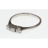 A three-stone diamond ring stamped 18ct, approx total weight 0.45ct & 2.