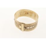 A gold plated bangle with embossed floral decoration and buckle style clasp, marked 9ct & silver,