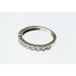 A diamond set half eternity ring, the nine stones approx total 0.50ct.