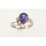 A pear-shaped tanzanite & diamond three stone ring, the central tanzanite approx 1.