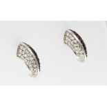 A pair of 18ct H/M black and white diamond set claw shaped earrings [VAT included in hammer price