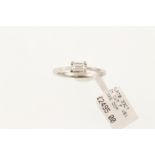 A platinum & diamond solitaire ring, the GIA certificated emerald cut diamond 0.