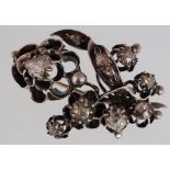 A Victorian diamond set floral brooch, unmarked silver & gold set,